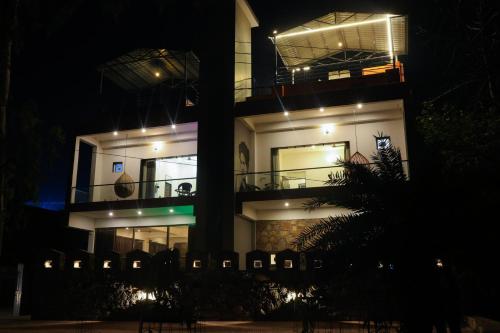a night view of a building with lights at Kailash Villa by Divine Stays in Udaipur