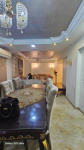 a living room with a table and chairs and a couch at أسيوط أبراج النصر in Asyut