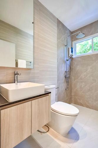 a bathroom with a white toilet and a sink at 4BR Luxury Pool Villa in Chiang Mai - Family-Friendly in Chiang Mai