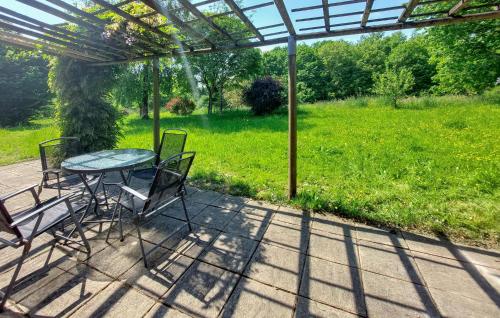 a table and chairs sitting under a pergola at Maison À La Campagne in Le Ferré