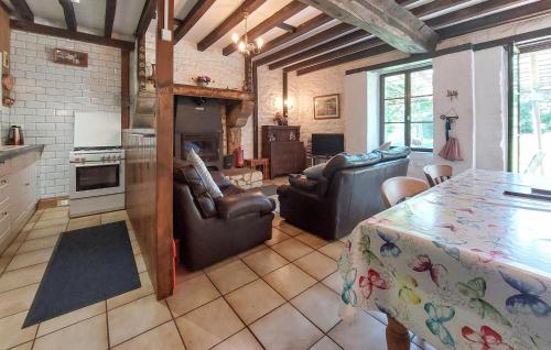 un salon avec des canapés et une table ainsi qu'une cuisine dans l'établissement Maison À La Campagne, à Le Ferré