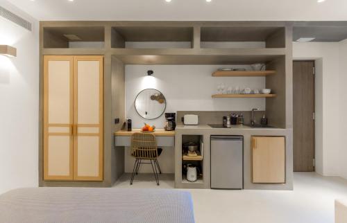 a small kitchen with a counter and a chair at Clementina Paros in Naousa