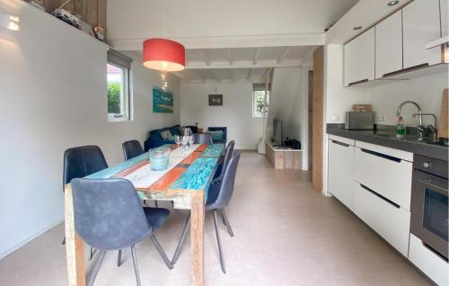 a kitchen and dining room with a table and chairs at 3 Bedroom Cozy Home In Stellendam in Stellendam