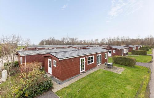 a row of small houses in a yard at Stunning Home In Wagenborgen With Wifi in Wagenborgen