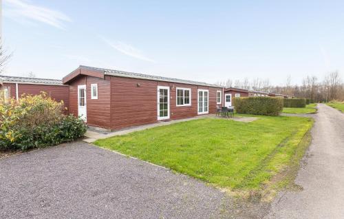 a small house with a yard in front of it at Amazing Home In Wagenborgen With Wifi in Wagenborgen