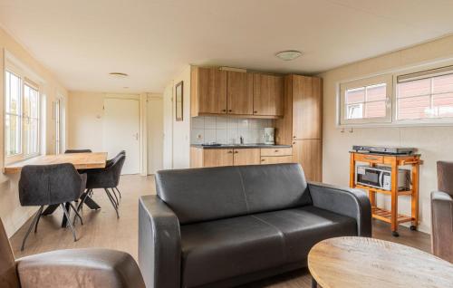 a living room with a couch and a table at Stunning Home In Wagenborgen With Wifi in Wagenborgen