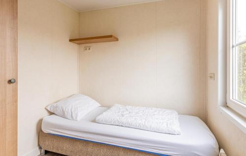 a small bed in a room with a window at 2 Bedroom Cozy Home In Wagenborgen in Wagenborgen
