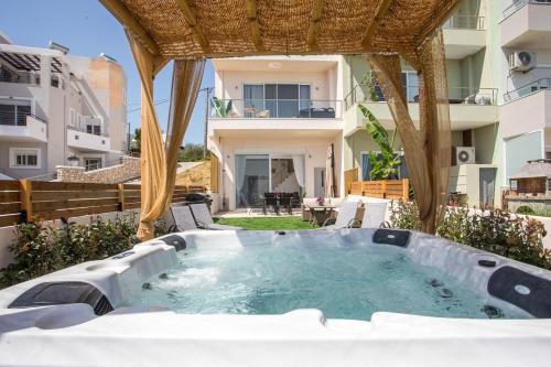 a hot tub in the backyard of a house at Zafora Garden in Koskinou