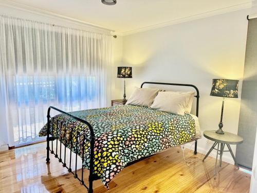 a bedroom with a bed and a window at Hill Cottage in Clare