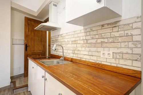 a kitchen with a wooden counter top and a sink at PUSHE Village Albayzin Art & Culture in Granada