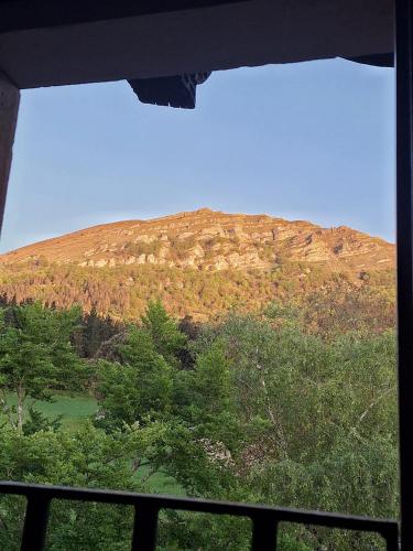 a view of a mountain from a window at Casa Rural Areano in Escoriaza