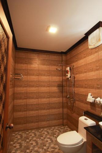 a bathroom with a toilet and a glass shower at Cabana Lipe Beach Resort in Ko Lipe