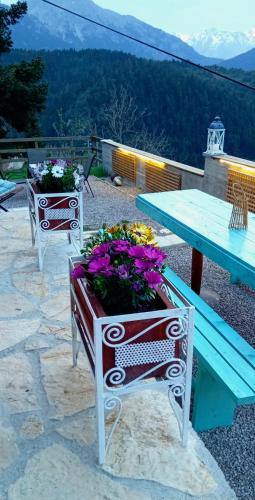 a table and two chairs with flowers on a patio at Villa Dremissa in Pávliani