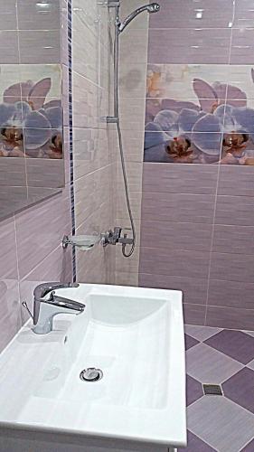 a bathroom with a sink and a shower at Guest House Fun and Rest in Plovdiv