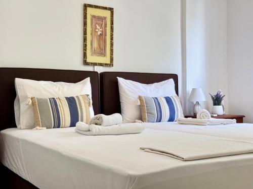 a bedroom with two beds with towels on them at Peaceful Apartment, in the nature, with yard "3" in Zipárion
