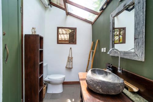 a bathroom with a sink and a toilet at Villa Maiya - Charming 1-Bedroom Villa with Pool in Gili Islands