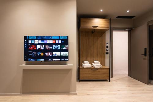 a large flat screen tv on a wall in a room at South Inn Hotel in Vlorë