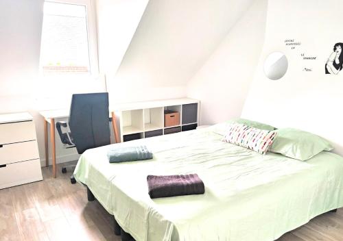 a bedroom with a large bed in a room at Le Duplex de Trouville - central - gare - commerces - marché in Trouville-sur-Mer