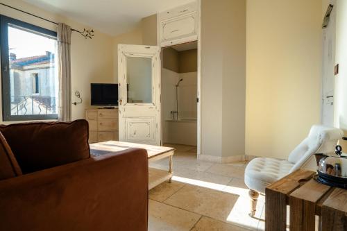 a living room with a couch and a chair at La Belle Vie in Saint-Hilaire-dʼOzilhan