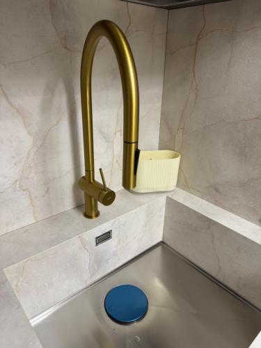 a sink with a gold faucet in a kitchen at Bethel House in Gardone Riviera