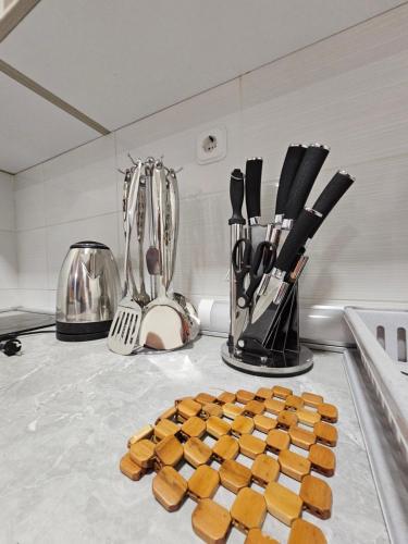 a bunch of food on a kitchen counter with utensils at Fantazy Apartment Main Square in Skopje