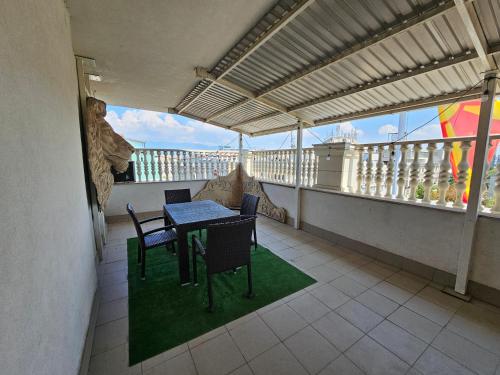 a balcony with a table and chairs on a roof at Fantazy Apartment Main Square in Skopje