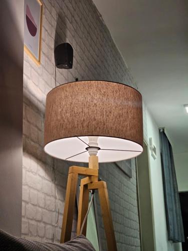 a lamp on a wooden stool in a room at Mother Teresa Apartments in Skopje