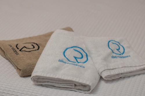 a pile of towels sitting on a bed at Olive Residence in Skala Fourkas