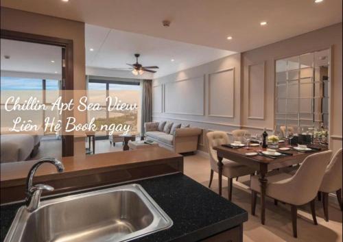a kitchen with a sink and a living room at Lux Chillin APT - Căn Hộ Hướng Biển Đà Nẵng in Danang