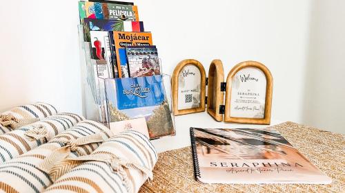 a table with books and mirrors on it at Seraphina Bookings Mojacar in Mojácar