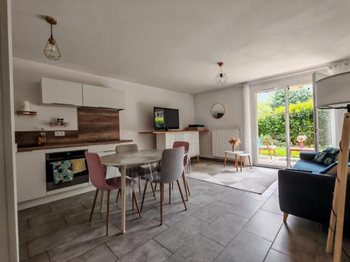 une cuisine et un salon avec une table et des chaises dans l'établissement Appartement avec jardin, à Saint-Gervais-les-Bains