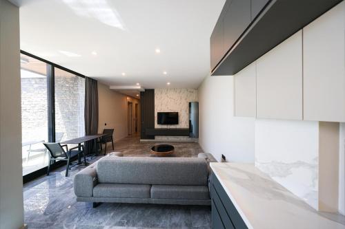 a living room with a couch and a table at Bodrum Ada Apart Otel Turgutreis in Mugla
