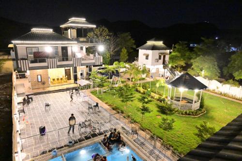 an aerial view of a house with a swimming pool at night at Popli Paradise Resort in Jaipur