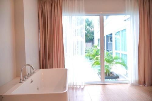 a bathroom with a sink and a large window at D Eco Wellness Center in North Pattaya
