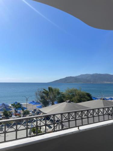 a view of the beach and the ocean from a balcony at Vythos Rooms in Paralion astros