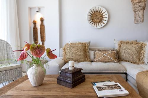 a living room with a couch and a table at Soborgo Exquisite Villas in Tinos Town