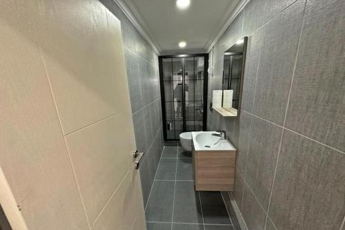 a bathroom with a sink and a mirror at Cloud Nine by Alara - Luxury Private Pool and Garden Villa in Beylikduzu