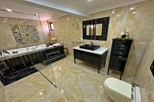 a bathroom with a sink and a shower and a toilet at Cloud Nine by Alara - Luxury Private Pool and Garden Villa in Beylikduzu