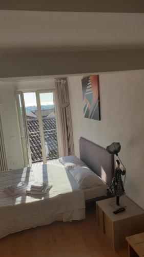 a bedroom with a bed and a lamp on a table at Aghèl Luxury Room in Recanati
