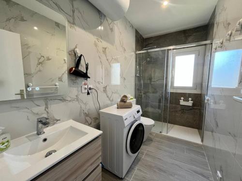 a bathroom with a toilet and a sink and a shower at Tu hogar de verano in Roses