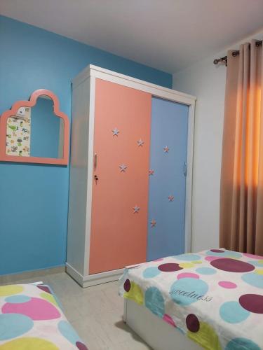 a bedroom with a bed and a large closet at شاليه مميز بقريه مارينا دلتا السياحيه olooool8369 in Al Ḩammād