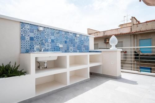 a balcony with a blue and white tile wall at Da Felicia in Capo dʼOrlando