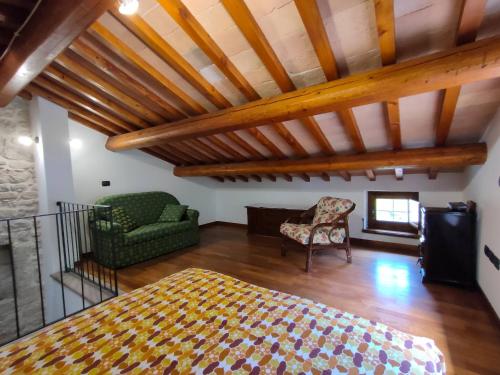 a bedroom with a bed and a chair in a room at Cottege in Pietra sul Fiume in Frontone