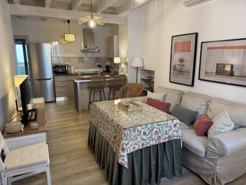 a living room with a couch and a table at Apartamentos La Gruta de Aracena 3 in Aracena
