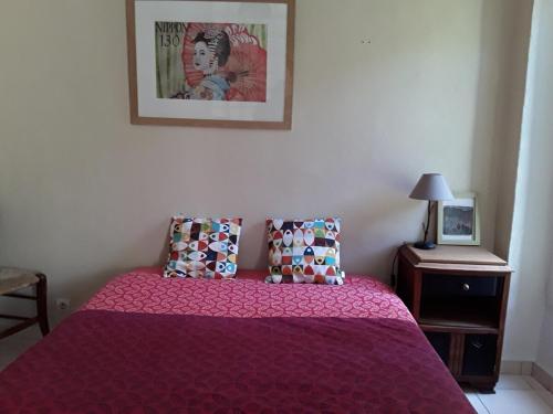 a bedroom with a bed with a purple bedspread at Maison de Hameau in Breil-sur-Roya