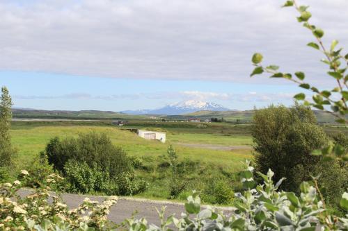 a view of a snow covered mountain in a field at Birtingaholt Retreat in Fludir