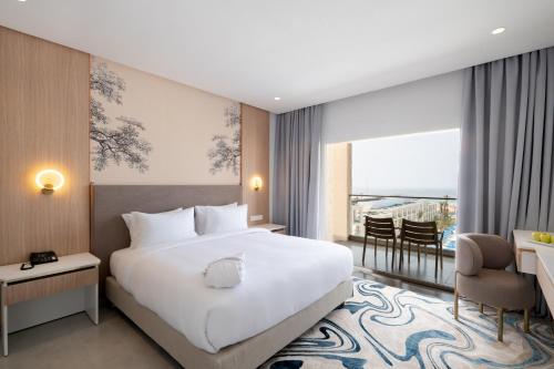 a hotel room with a bed and a balcony at Pickalbatros Palais Des Roses - Agadir - All Inclusive in Agadir