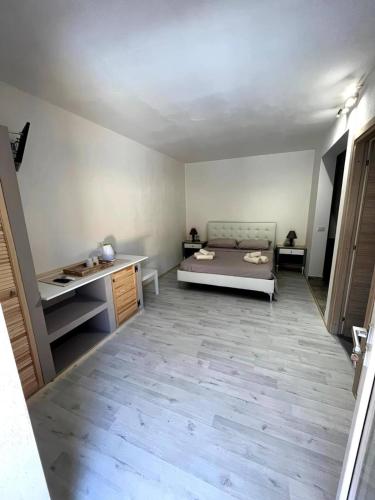 a large room with a bed and a desk at B&B Salaju in Castelsardo