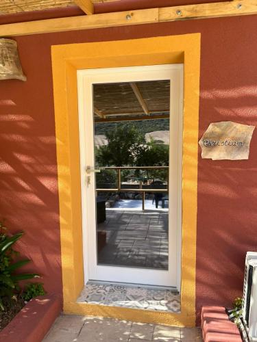 a door to a building with a balcony at B&B Salaju in Castelsardo