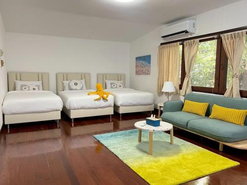 a living room with two beds and a yellow toy on a table at AT ASok Vintage House Near BTS Asok MRT Sukhumvit in Khlong Toei